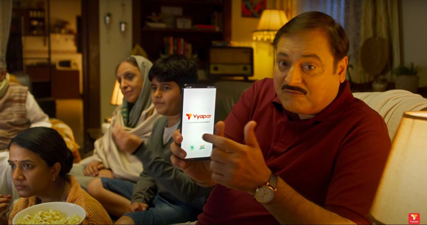 A family watches a Vyapar campaign film together